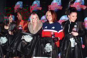 The Spice Girls' Posh Spice (Victoria Adams) (L) -- Scary Spice (Melanie Janine Brown) (2nd-L) -- Baby Spice (Emma Lee Burton) (C) -- Ginger Spice (Geraldine Halliwell) (2nd-R) -- and Sporty Spice (Melanie Jayne Chisolm) (R)  --  pose for photographers with their Planet Hollywood jackets after they arrived for a screening of their new movie "Spice World" at Planet Hollywood in New York 14 January.    AFP PHOTO  Henny Ray ABRAMS (Photo credit should read HENNY RAY ABRAMS/AFP via Getty Images)