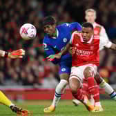  Noni Madueke of Chelsea is challenged by Gabriel of Arsenal, before scoring the team’s first goal (Photo by Shaun Botterill/Getty Images)