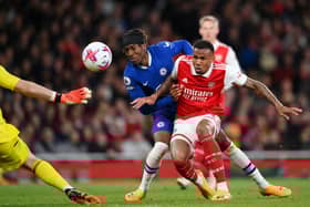  Noni Madueke of Chelsea is challenged by Gabriel of Arsenal, before scoring the team’s first goal (Photo by Shaun Botterill/Getty Images)