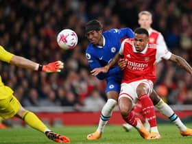  Noni Madueke of Chelsea is challenged by Gabriel of Arsenal, before scoring the team’s first goal (Photo by Shaun Botterill/Getty Images)