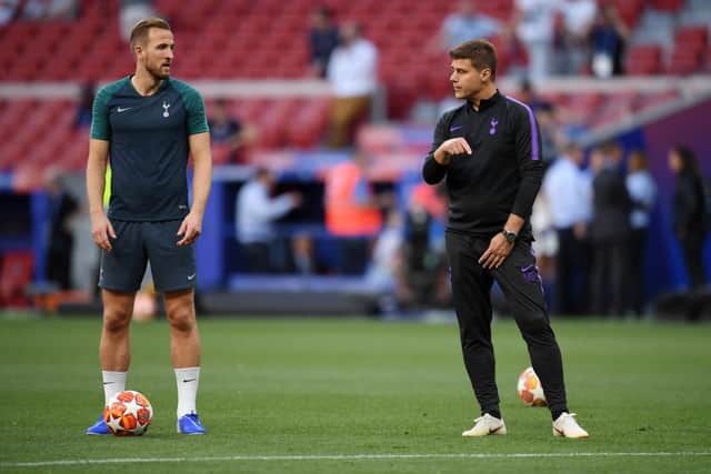 Mauricio Pochettino, Manager of Tottenham Hotspur speaks with Harry Kane of Tottenham Hotspur (Photo by Matthias Hangst/Getty Images)