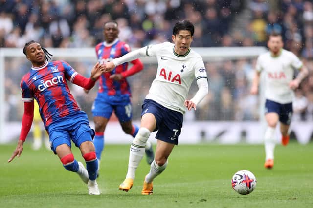 Son Heung-min runs with the ball whilst under pressure from Michael Olise. (Photo by Warren Little/Getty Images)