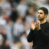 Arsenal head coach Mikel Arteta applauds fans at St James' Park.