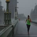 A runner crosses Westminster Bridge during a thunderstorm in 2020. (Photo by Dan Kitwood/Getty Images)