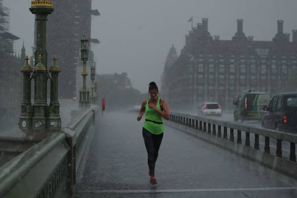 A runner crosses Westminster Bridge during a thunderstorm in 2020. (Photo by Dan Kitwood/Getty Images)