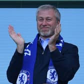 Chelsea’s Russian owner Roman Abramovich applauds, as players celebrate their league title win  (Photo by BEN STANSALL/AFP via Getty Images)