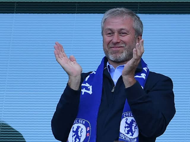Chelsea’s Russian owner Roman Abramovich applauds, as players celebrate their league title win  (Photo by BEN STANSALL/AFP via Getty Images)