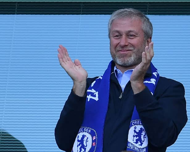 Chelsea’s Russian owner Roman Abramovich applauds, as players celebrate their league title win  (Photo by BEN STANSALL/AFP via Getty Images)