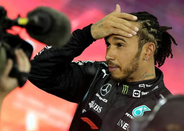 Second-placed Mercedes' British driver Lewis Hamilton reacts in the parc ferme of the Yas Marina Circuit after the Abu Dhabi Formula One Grand Prix on December 12, 2021 (Getty Images)