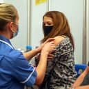 Caroline Nicolls receives an injection of the Moderna Covid-19 vaccine administered by nurse Amy Nash, at the Madejski Stadium, Reading (Getty Images)
