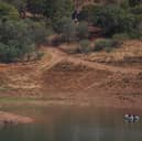 Portuguese firefighterOfficials are seen during a new search operation amid the investigation into the disappearance of Madeleine McCann in the Arade dam, in Silves, near Praia da Luz, on 23 May, 2023.