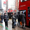 People queue to board a London bus. Credit: Tolga Akmen/AFP via Getty Images.