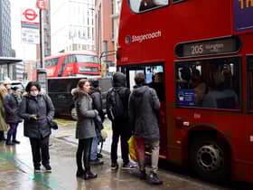 People queue to board a London bus. Credit: Tolga Akmen/AFP via Getty Images.