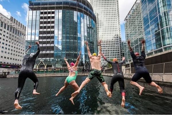 Swimmers jumping into Middle Dock. Credit: Canary Wharf Group.