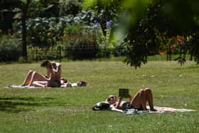 Sunbathers in St James’ Park, London.