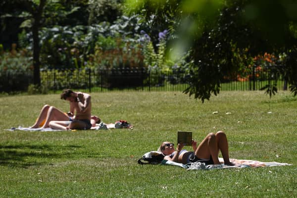 Sunbathers in St James’ Park, London.