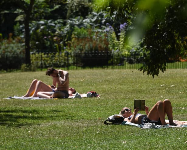 Sunbathers in St James’ Park, London.