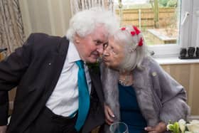 Joan Neininger & Ken Selway share a kiss at their wedding reception at Hannover Court, Cinderford, Gloucestershire. 