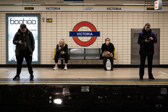 Passengers waiting at Victoria Tube station