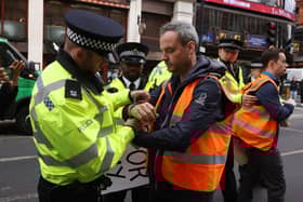 Police make arrests as Just Stop Oil protesters walk down Shaftesbury Avenue on June 7. (Photo by Dan Kitwood/Getty Images)