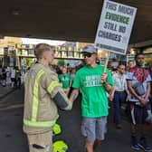 A group of firefighters, wearing Grenfell hero badges, formed a guard of honour opposite Ladbroke Grove Tube station in an emotional display of solidarity. 