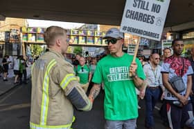 A group of firefighters, wearing Grenfell hero badges, formed a guard of honour opposite Ladbroke Grove Tube station in an emotional display of solidarity. 