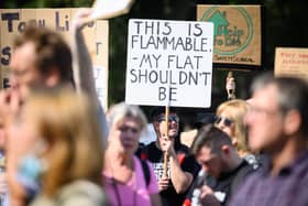 Supporters of leasehold reform campaign groups hold placards as they protest outside the Houses of Parliament. Credit: Leon Neal/Getty Images.