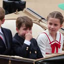 Prince George, Princess Charlotte and Prince Louis, who has apparently smelt something, ride in a horse drawn carriage with Catherine, Princess of Wales and Queen Camilla during Trooping the Colour at Horse Guards Parade. (Photo by Rob Pinney/Getty Images)