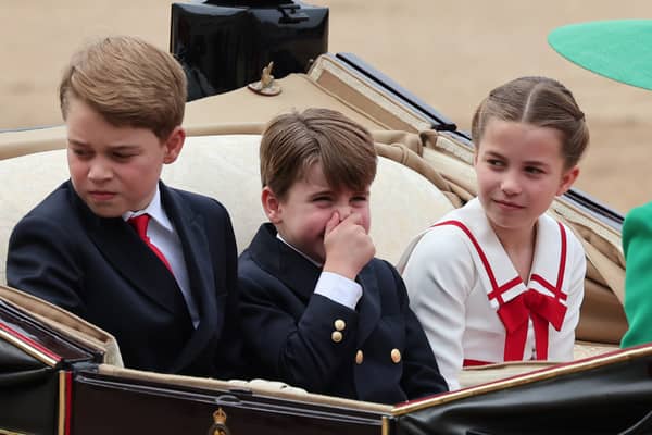 Prince George, Princess Charlotte and Prince Louis, who has apparently smelt something, ride in a horse drawn carriage with Catherine, Princess of Wales and Queen Camilla during Trooping the Colour at Horse Guards Parade. (Photo by Rob Pinney/Getty Images)