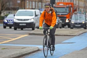 A cyclist rides a bicycle along the Cycle Superhighway in Oval, in South London. Credit: Susannah Ireland/AFP via Getty Images.