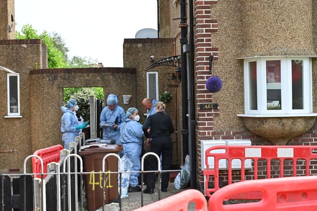 Police and forensics at the scene in Bedfont. (SWNS)