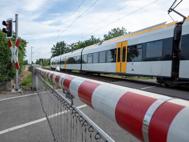 A CCTV clip has shown the heart-stopping moment a woman has a near miss with a train on a level crossing