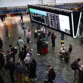 Passengers at London Euston station earlier in June. (Photo by HENRY NICHOLLS/AFP via Getty Images)