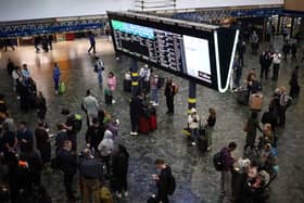 Passengers at London Euston station earlier in June. (Photo by HENRY NICHOLLS/AFP via Getty Images)