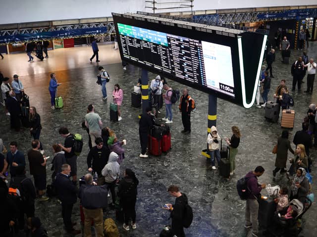 Passengers at London Euston station earlier in June. (Photo by HENRY NICHOLLS/AFP via Getty Images)
