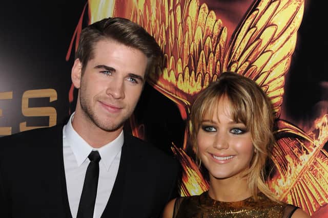 LOS ANGELES, CA - MARCH 12:  Actors Liam Hemsworth (L) and Jennifer Lawrence arrive at the premiere of Lionsgate's "The Hunger Games" at Nokia Theatre L.A. Live on March 12, 2012 in Los Angeles, California.  (Photo by Kevin Winter/Getty Images)