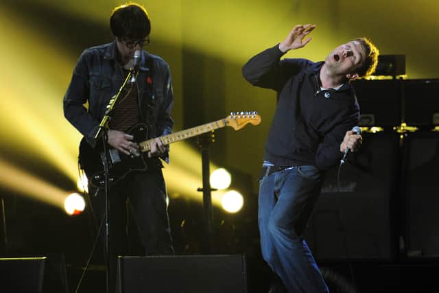 Graham Coxon and Damon Albarn at the end Brit Awards 2012. (Photo by LEON NEAL/AFP via Getty Images)