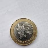 The £2 coin features the official mascot of the games, Tosha the Cat, as well as the logo of the games.