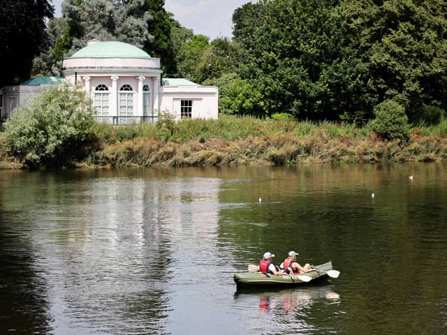 A couple canoe down the river Thames near Richmond, southwest London. Credit: Tolga Akmen / AFP via Getty Images.