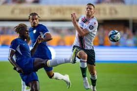 Trevoh Chalobah #14 of Chelsea FC kicks the ball away from Paul Mullin #10 of Wrexham  (Photo by Jacob Kupferman/Getty Images)