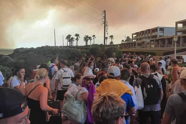 Tourists are evacuated from hotels during a wildfire on the Greek island of Rhodes on July 22, 2023.