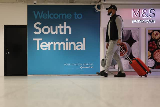 A traveller at the south terminal in Gatwick Airport. Credit: Hollie Adams/Getty Images.
