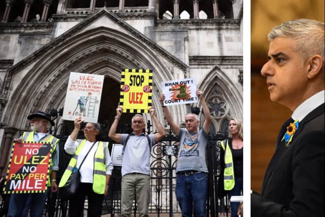 Anti-ULEZ expansion campaigners hold placards outside the High Court ahead of the ruling that Sadiq Khan's ULEZ expansion to outer London boroughs can go ahead. (Photo by Carl Court/Getty Images)
