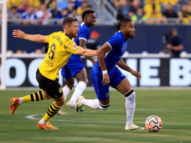 Christopher Nkunku #45 of Chelsea FC controls the ball while defended by Salih Ozcan #6 of Borussia  (Photo by Justin Casterline/Getty Images)