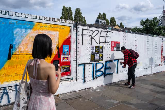 A man sprays ‘Free Tibet’ over an area of wall that had been graffitied with Chinese Communist Party ideology on Monday August 7, 2023 in Brick Lane. (Photo by Carl Court/Getty Images)