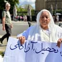 Grandmother holds placard reading ‘work, education, freedom’ in Parliament Square. Credit: Shabnam Nasimi