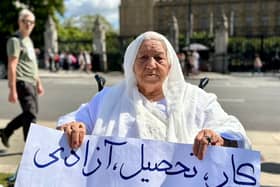 Grandmother holds placard reading ‘work, education, freedom’ in Parliament Square. Credit: Shabnam Nasimi