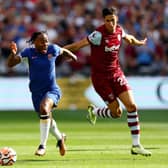 Raheem Sterling of Chelsea runs with the ball whilst under pressure from Nayef Aguerd (Photo by Clive Rose/Getty Images)