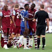 Nicolas Jackson of Chelsea is confronted by Kurt Zouma of West Ham United as he speaks to referee John Brooks  (Photo by Julian Finney/Getty Images)