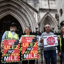 Demonstrators protest against the expansion of the Ultra Low Emission Zone (ULEZ), outside the Royal Courts of Justice in July. (Photo by HENRY NICHOLLS/AFP via Getty Images)